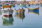 Malta, Marsaxlokk. Marsaxlokk harbor. Luzzijiet, colorful traditional Maltese fishing boats. Art Print